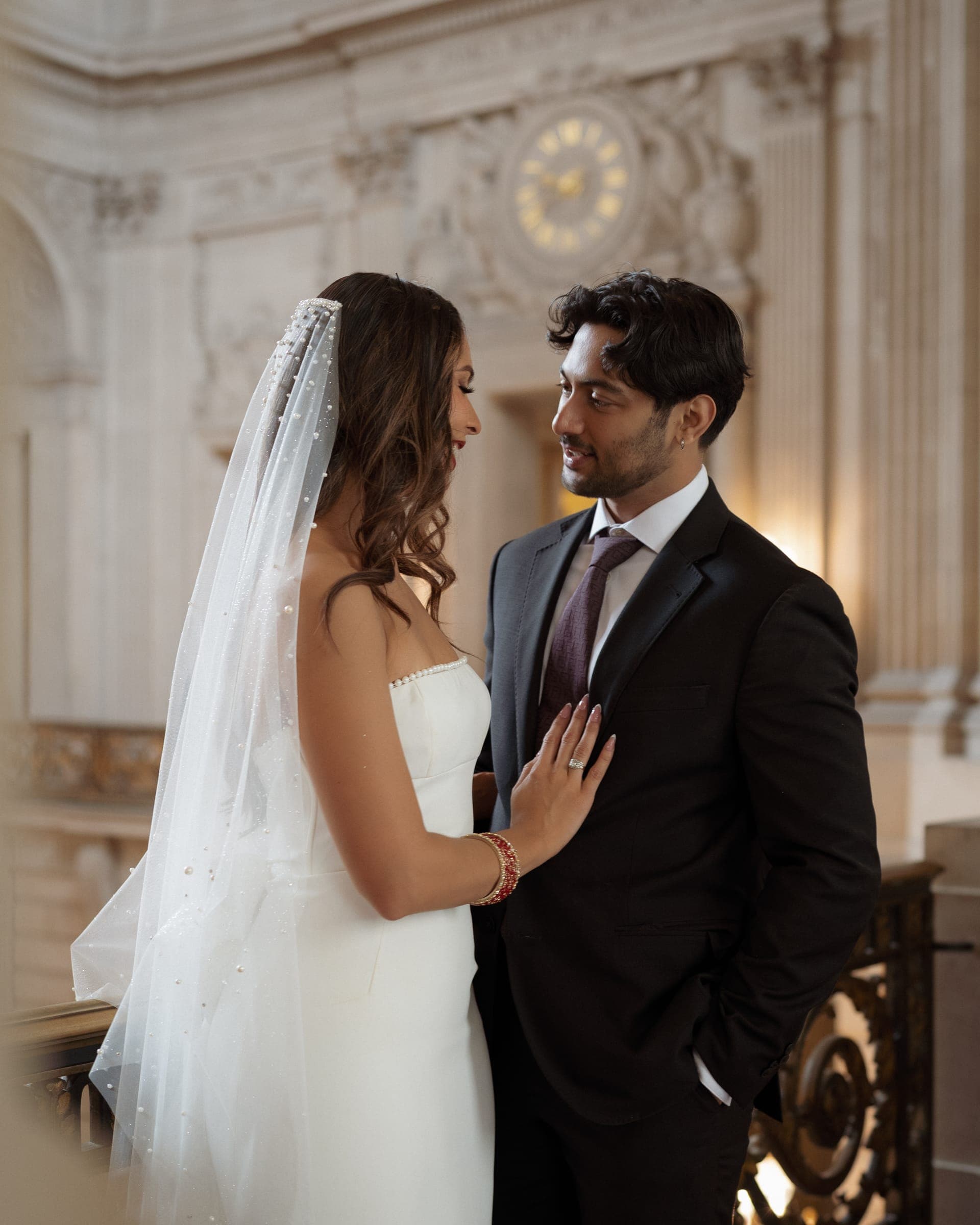 Bishal and Anna gazing at each other on the grand staircase